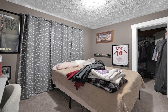 carpeted bedroom with a spacious closet, a closet, and a textured ceiling