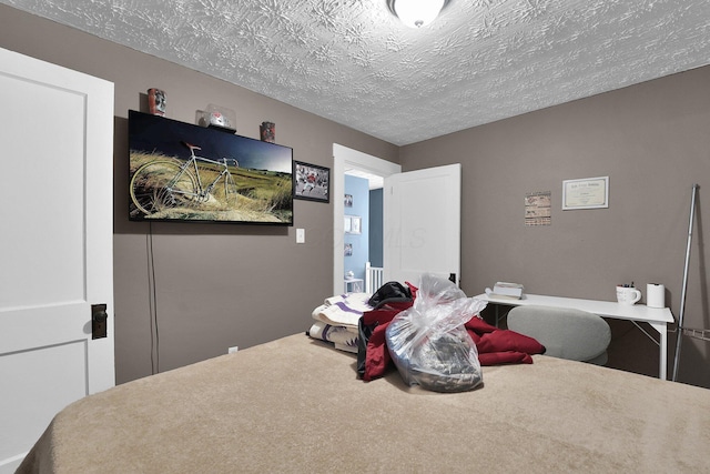 carpeted bedroom with a textured ceiling