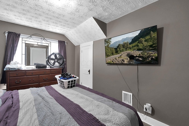 bedroom with visible vents, a textured ceiling, carpet, and vaulted ceiling