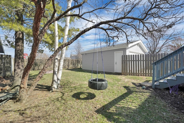 view of yard featuring an outdoor structure and fence