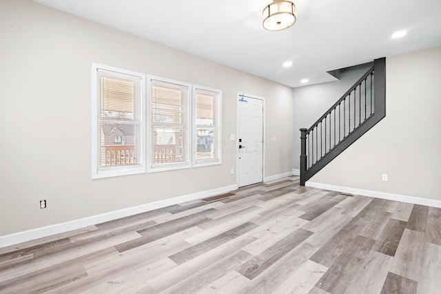 foyer featuring stairway, recessed lighting, baseboards, and light wood finished floors