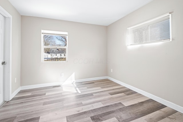 unfurnished room featuring wood finished floors and baseboards