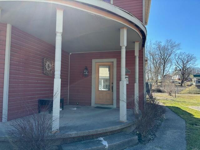 property entrance featuring a carport and covered porch