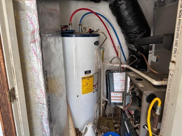 utility room featuring water heater