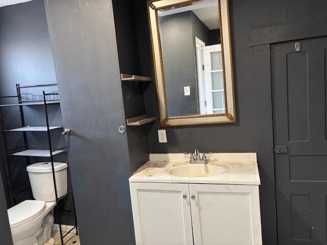 half bathroom featuring toilet and vanity