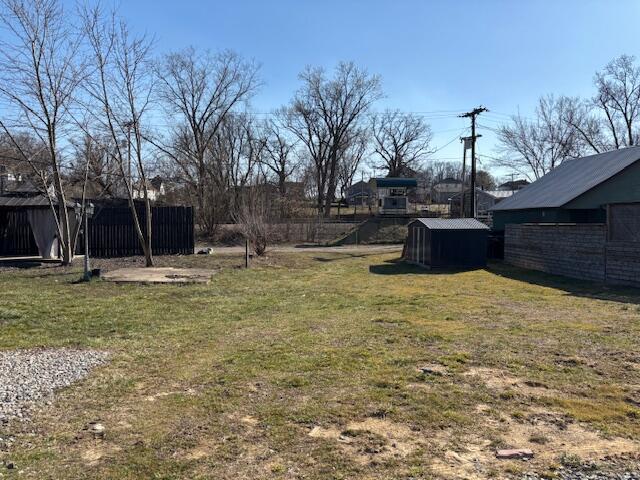 view of yard with an outbuilding and a shed