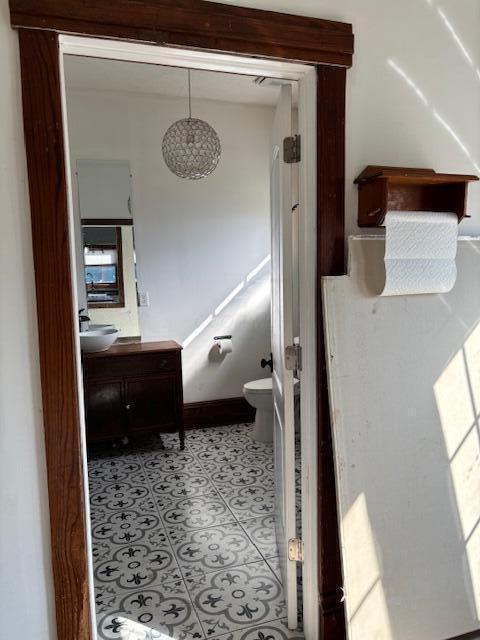 bathroom featuring toilet, vanity, and tile patterned flooring