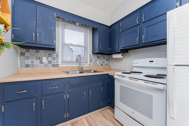 kitchen with white appliances, light countertops, blue cabinets, and a sink