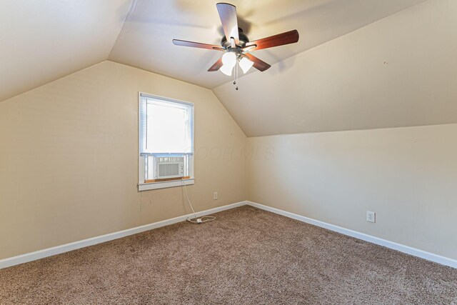 additional living space with lofted ceiling, carpet, baseboards, and ceiling fan