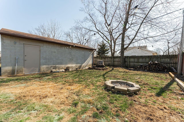 view of yard with a fenced backyard and an outdoor fire pit