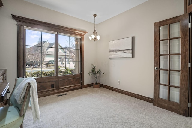 carpeted home office with visible vents, baseboards, and an inviting chandelier