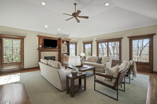 living area featuring recessed lighting, lofted ceiling, a healthy amount of sunlight, and a fireplace