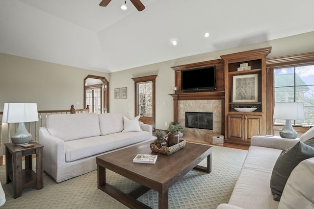 living area featuring ceiling fan, lofted ceiling, recessed lighting, and a premium fireplace