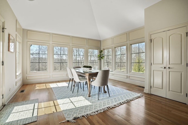 unfurnished sunroom featuring visible vents, plenty of natural light, and vaulted ceiling