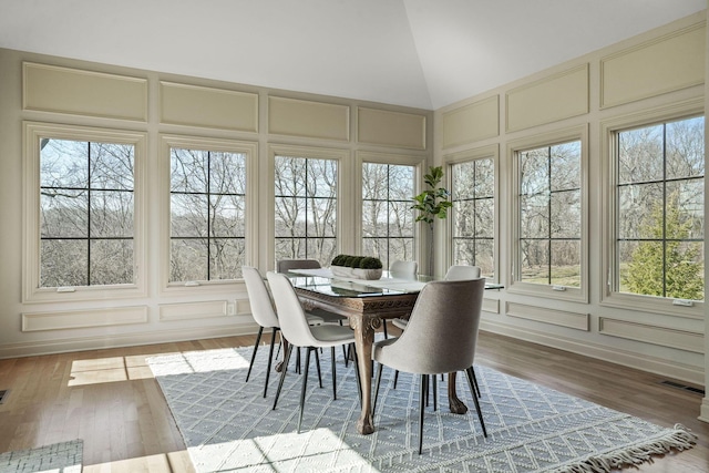 sunroom / solarium with lofted ceiling and visible vents