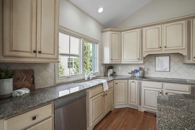 kitchen with dark wood-type flooring, cream cabinetry, black electric cooktop, dishwasher, and vaulted ceiling