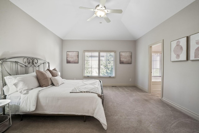 carpeted bedroom featuring vaulted ceiling, connected bathroom, baseboards, and ceiling fan