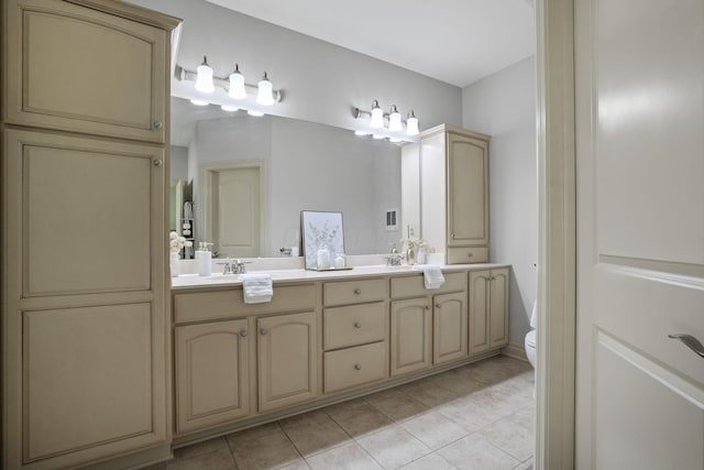 full bath featuring tile patterned floors, toilet, double vanity, and a sink