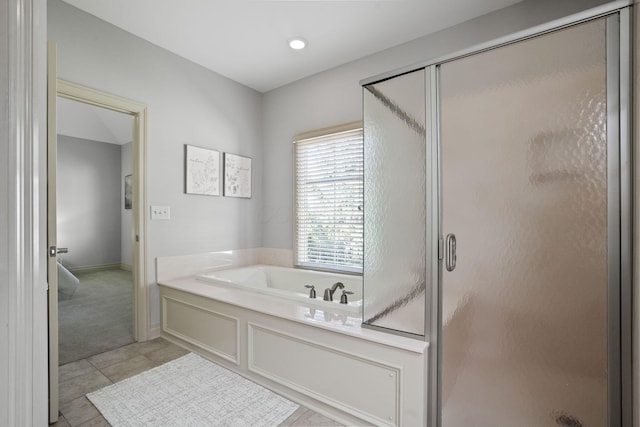 full bathroom with tile patterned floors, a bath, and a shower stall