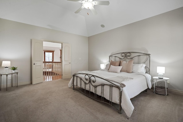 carpeted bedroom with a ceiling fan, baseboards, and vaulted ceiling