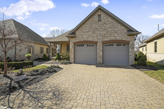 view of front of property featuring decorative driveway and an attached garage