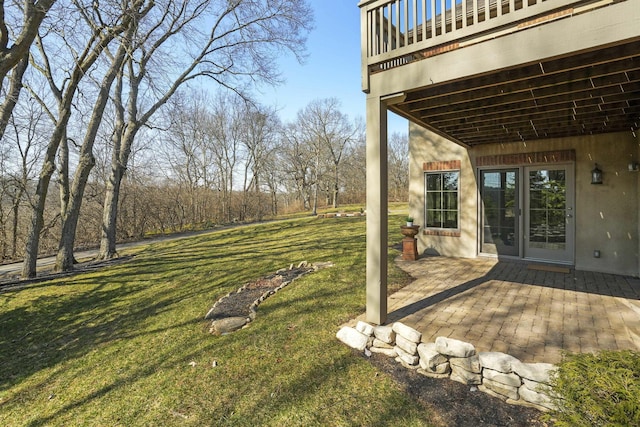 view of yard with a patio area and a balcony