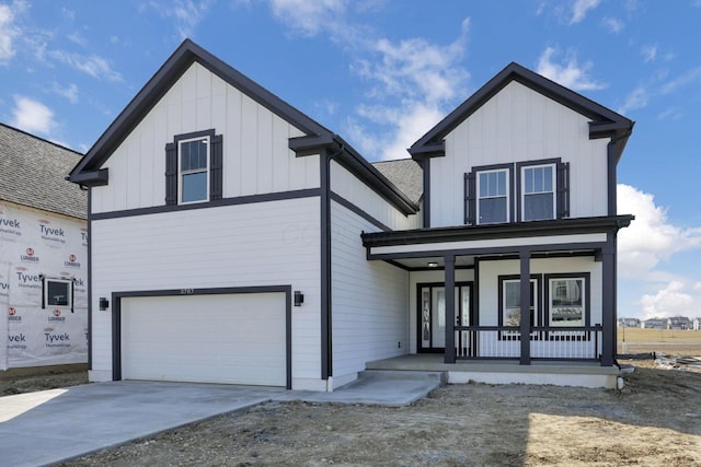 view of front of home featuring a porch, a garage, board and batten siding, and driveway