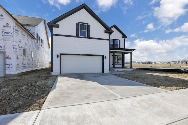 modern farmhouse style home featuring a garage, board and batten siding, and driveway