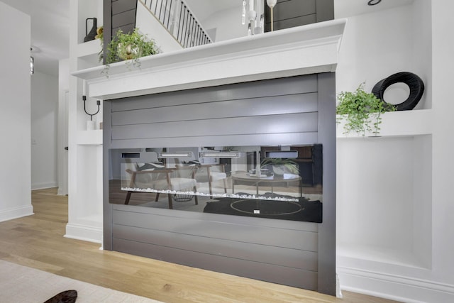 room details featuring baseboards and wood finished floors