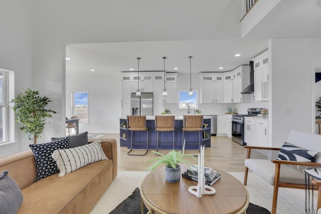 living room with recessed lighting and light wood-style flooring