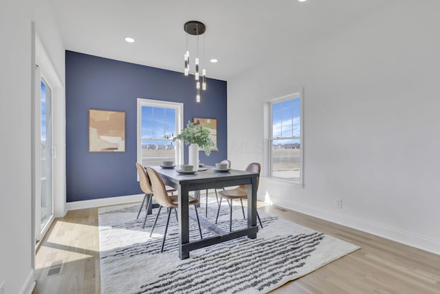 dining room featuring recessed lighting, wood finished floors, visible vents, and baseboards