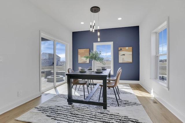 office space featuring light wood-type flooring, visible vents, baseboards, and recessed lighting