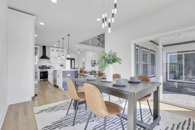 dining room with recessed lighting and light wood finished floors