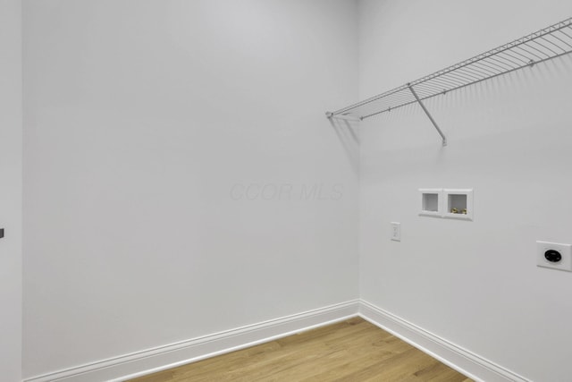 laundry room featuring baseboards, light wood-type flooring, washer hookup, laundry area, and electric dryer hookup