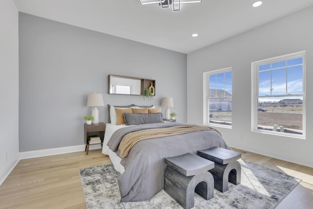 bedroom with recessed lighting, baseboards, and light wood-style flooring