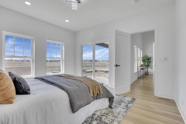 bedroom featuring visible vents, access to outside, recessed lighting, light wood-style floors, and baseboards