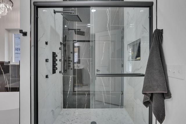 full bath featuring a marble finish shower