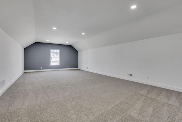 bonus room featuring carpet floors, baseboards, and vaulted ceiling