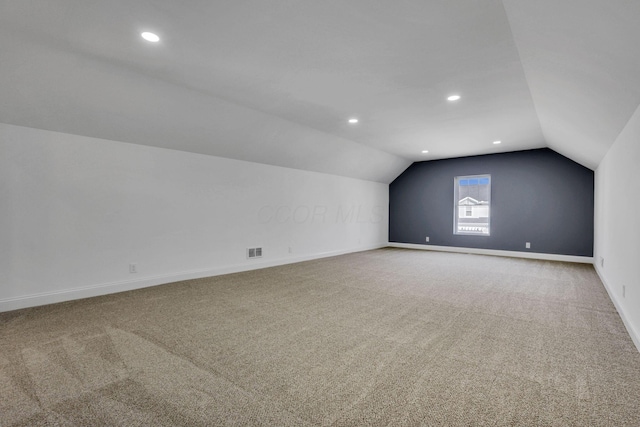 bonus room with visible vents, lofted ceiling, carpet, and baseboards