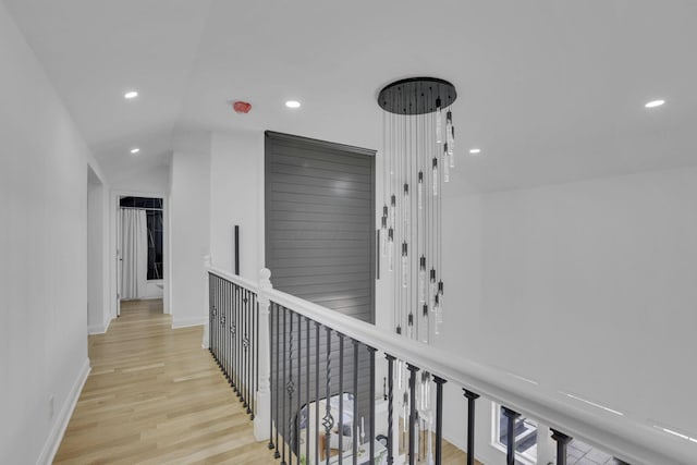 hall with recessed lighting, baseboards, lofted ceiling, and wood finished floors