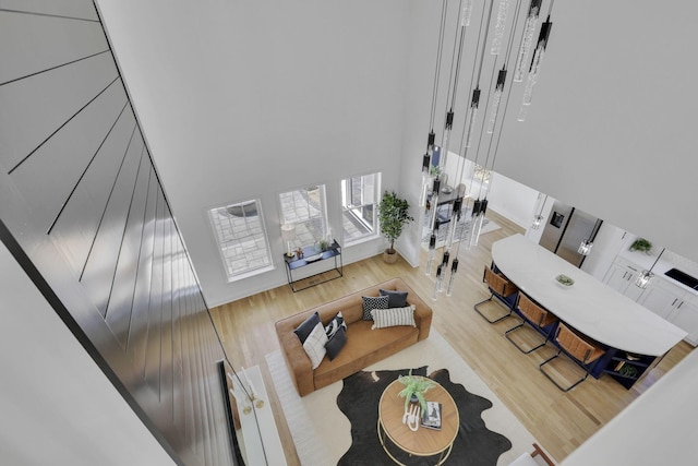 living room with a high ceiling and wood finished floors