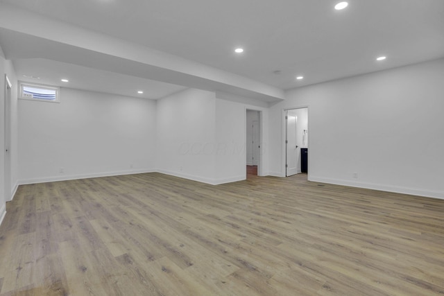 below grade area featuring recessed lighting, baseboards, and wood finished floors