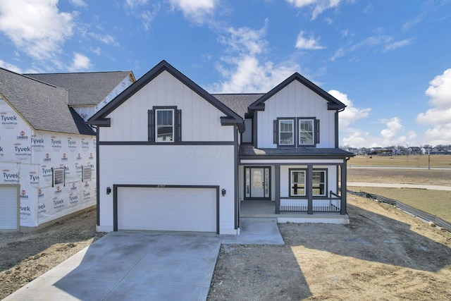 view of front facade featuring driveway, a porch, board and batten siding, an attached garage, and a shingled roof