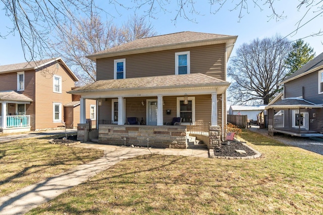 american foursquare style home with a porch, a front lawn, and a shingled roof