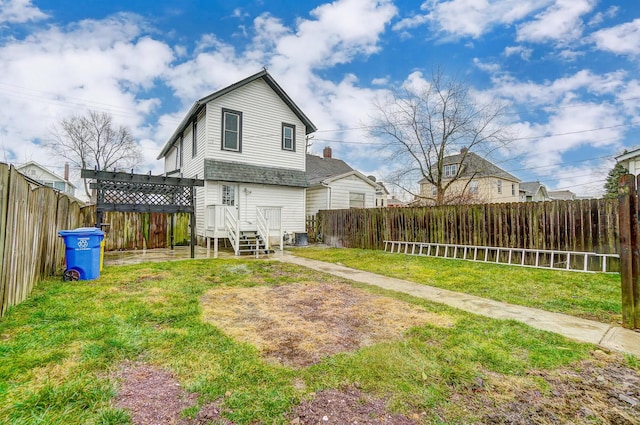 rear view of house featuring central air condition unit, a lawn, a fenced backyard, and roof with shingles