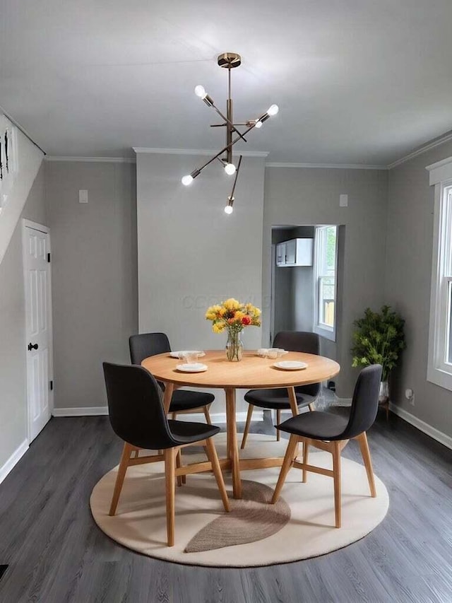 dining space with baseboards, ornamental molding, and dark wood-style flooring