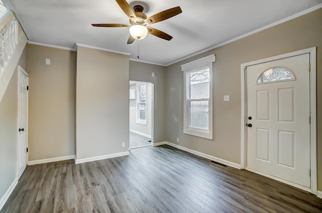 foyer with baseboards, wood finished floors, and ornamental molding