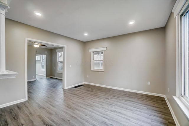 empty room with recessed lighting, a ceiling fan, baseboards, and wood finished floors