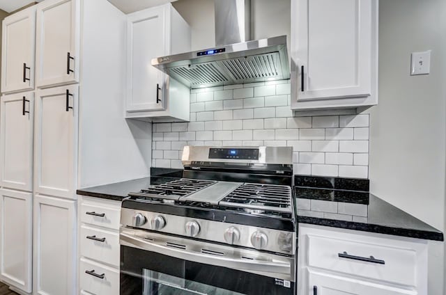 kitchen with white cabinetry, wall chimney exhaust hood, tasteful backsplash, and stainless steel gas stove