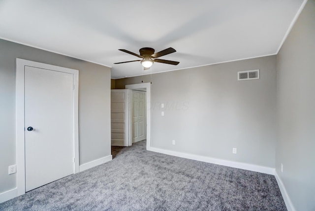 unfurnished bedroom featuring a ceiling fan, carpet flooring, baseboards, and visible vents